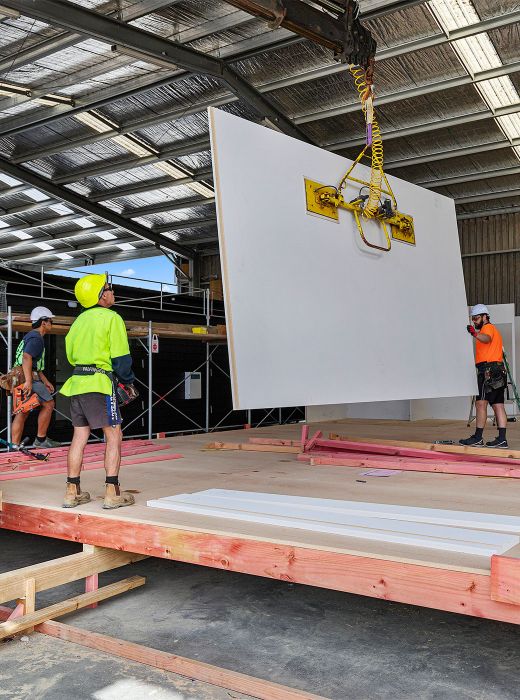 Metra panel craned in to place in under cover building factory