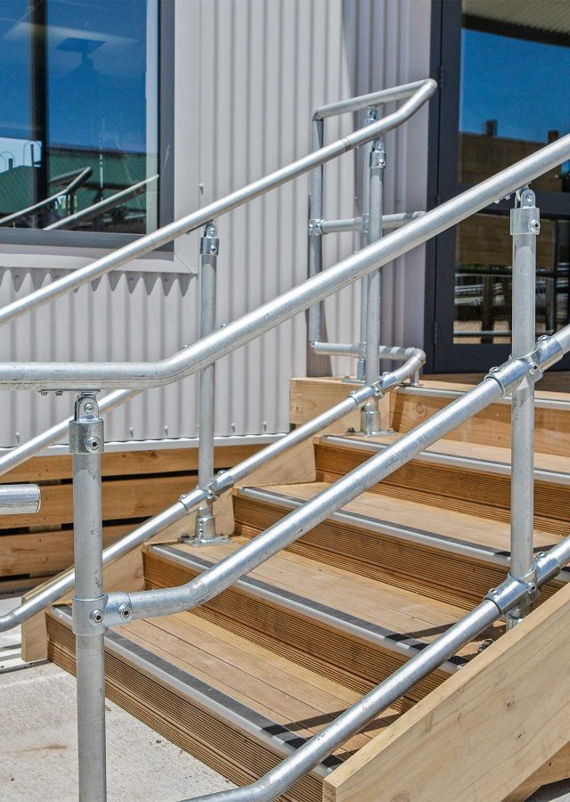 Steps with steel hand rails leading up to classroom